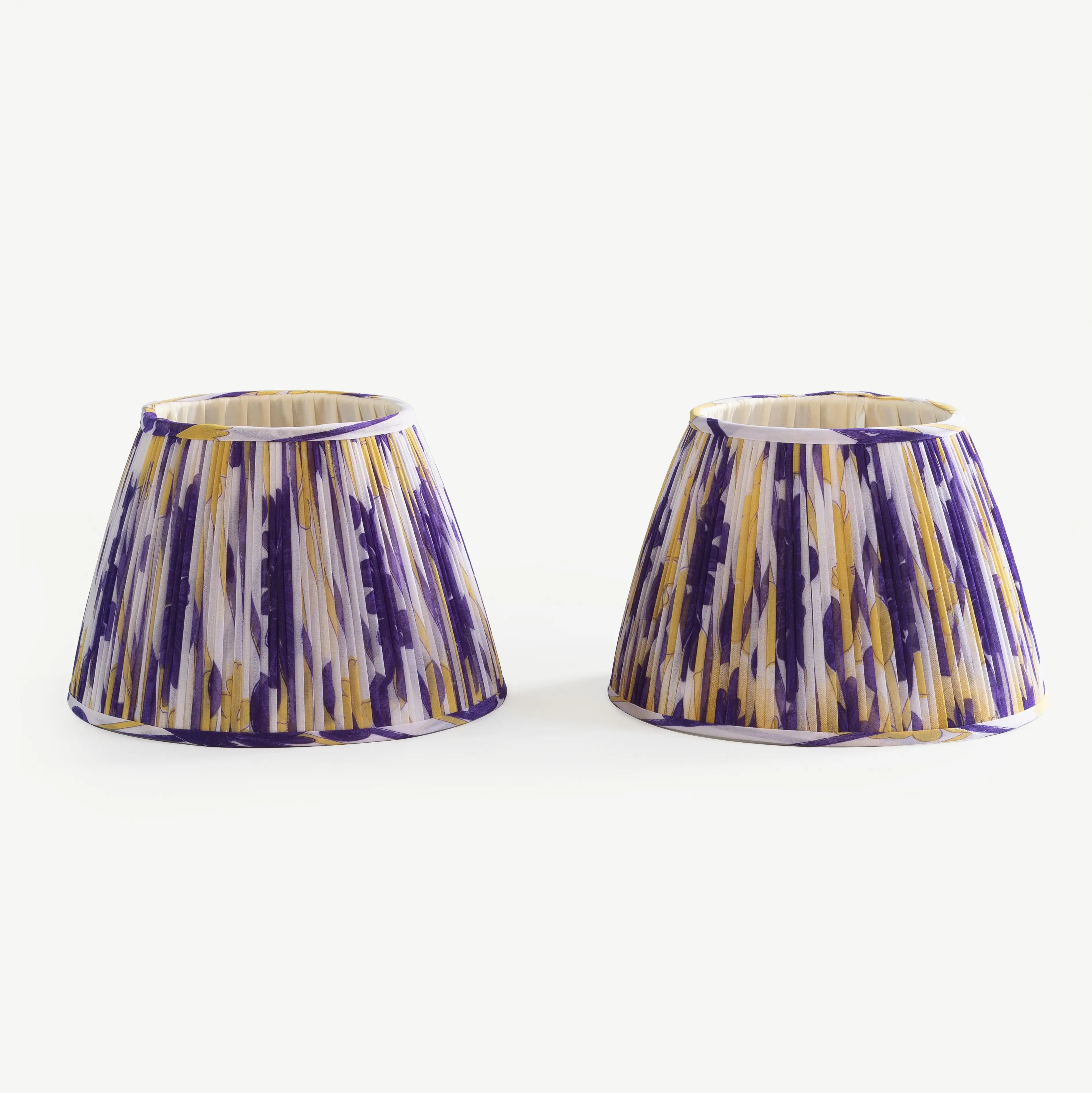 A pair of blue, yellow and white lampshades