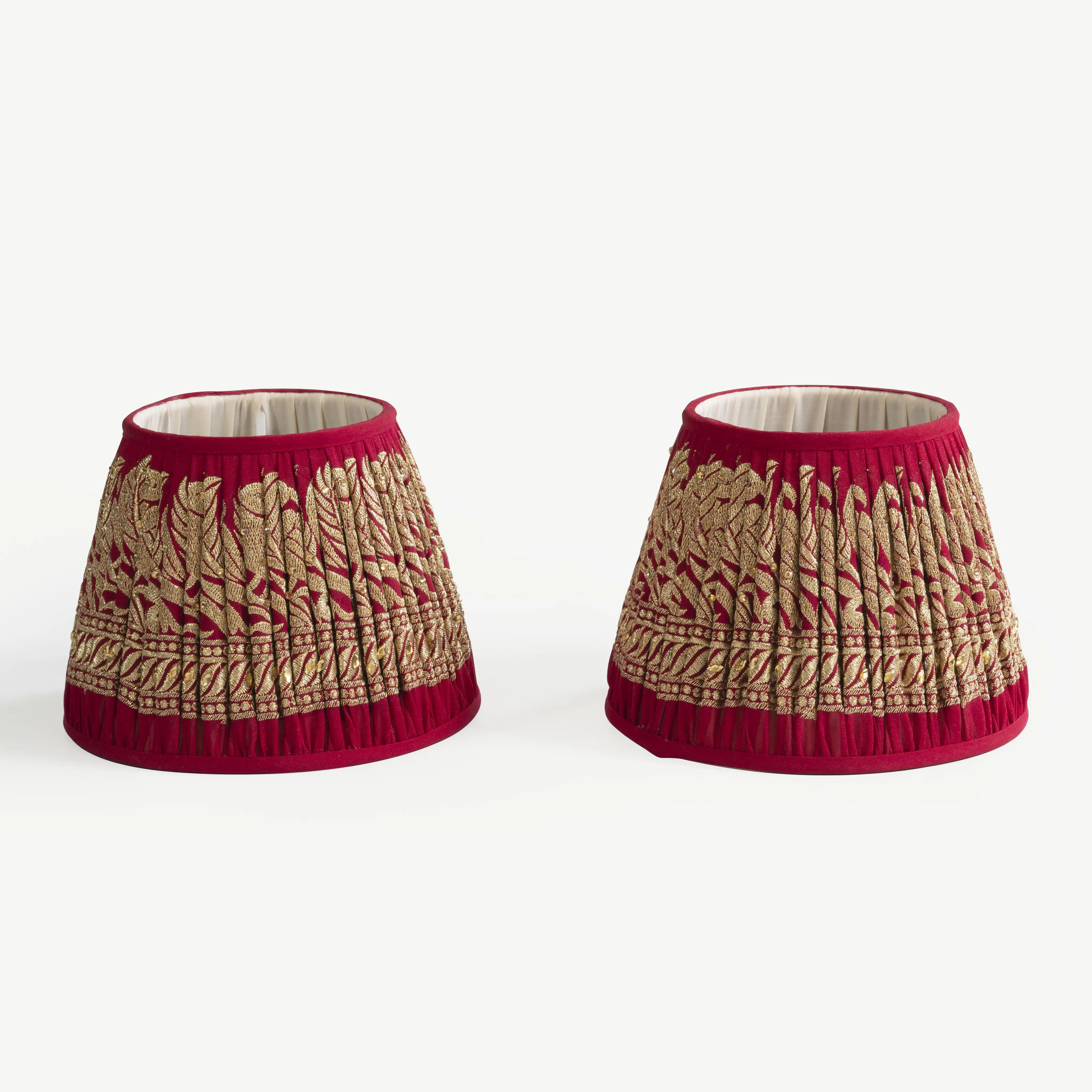 A pair of red and gold lampshades