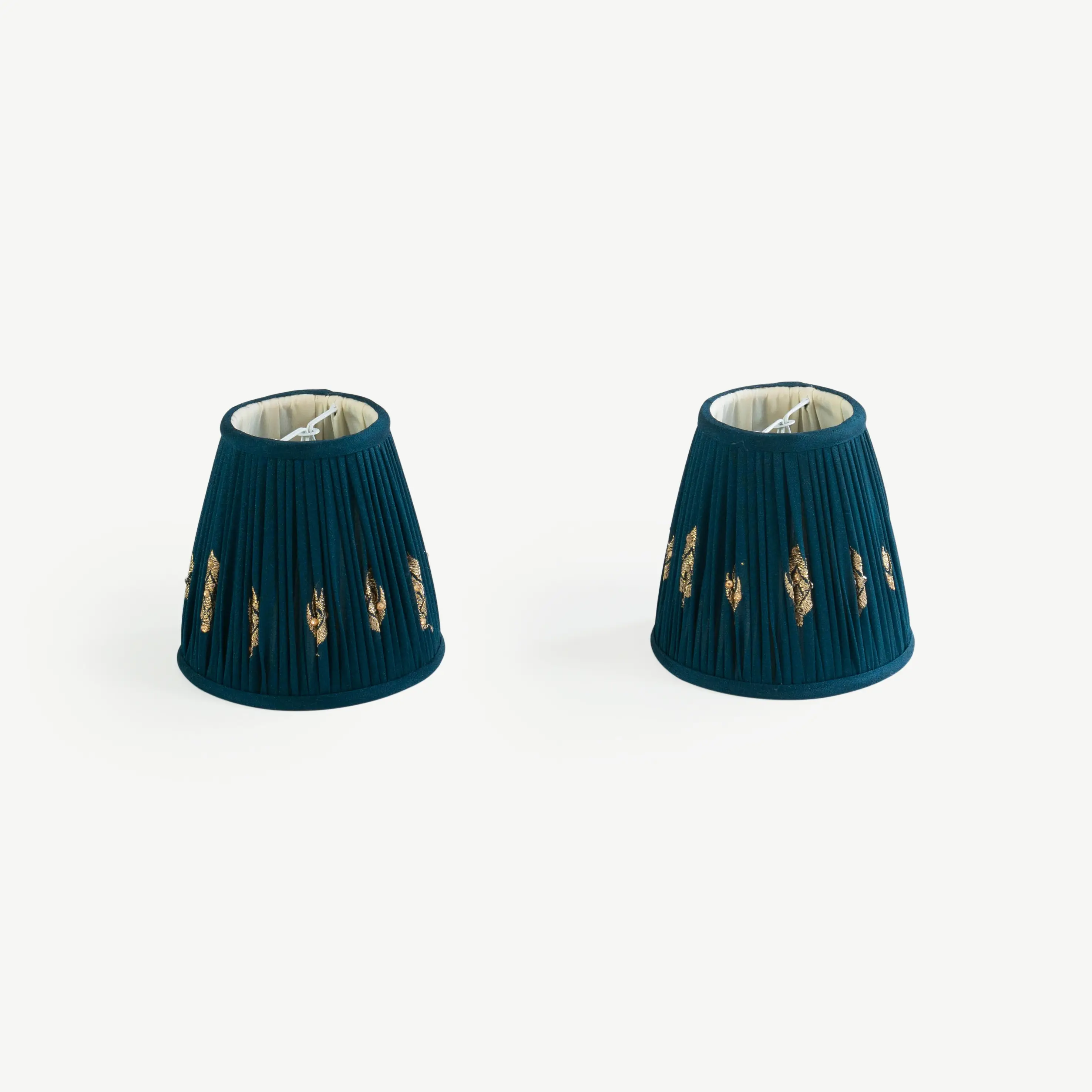 A pair of dark turquoise lampshades