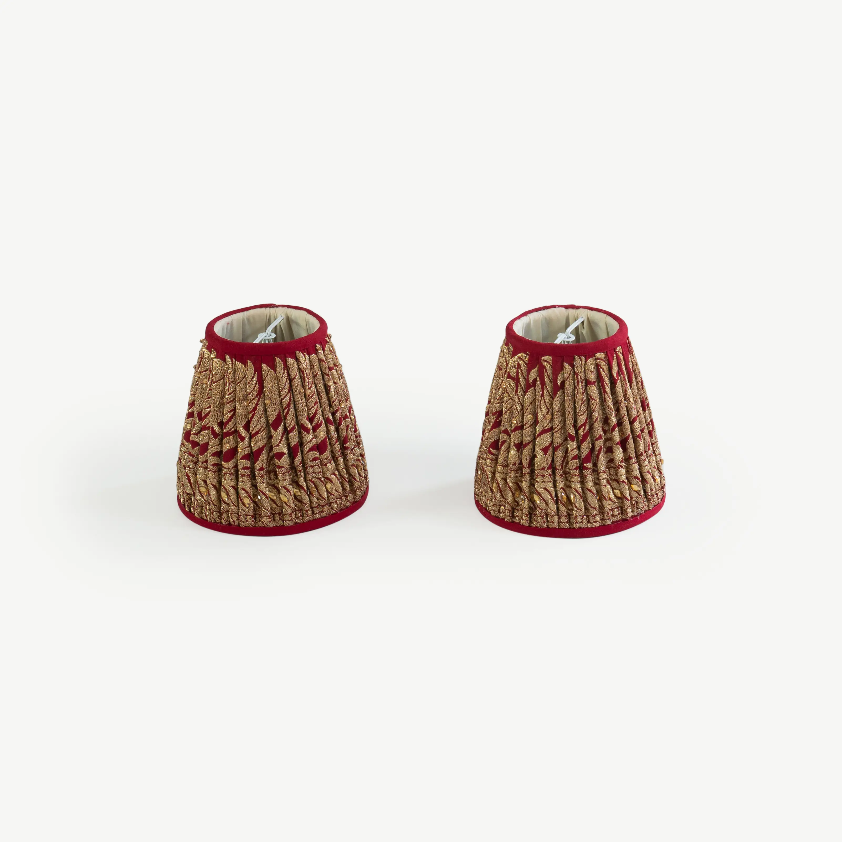 A pair of red and gold lampshades